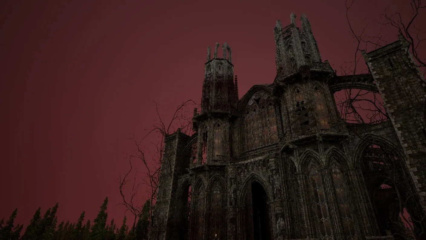 The ruined church against a deep red sky, bare branches across its towers